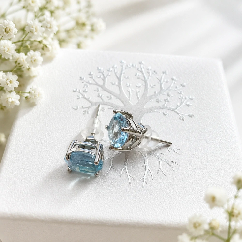 Topaz fazetované náušnice ovál 5 × 7 mm, Ag 925/1000